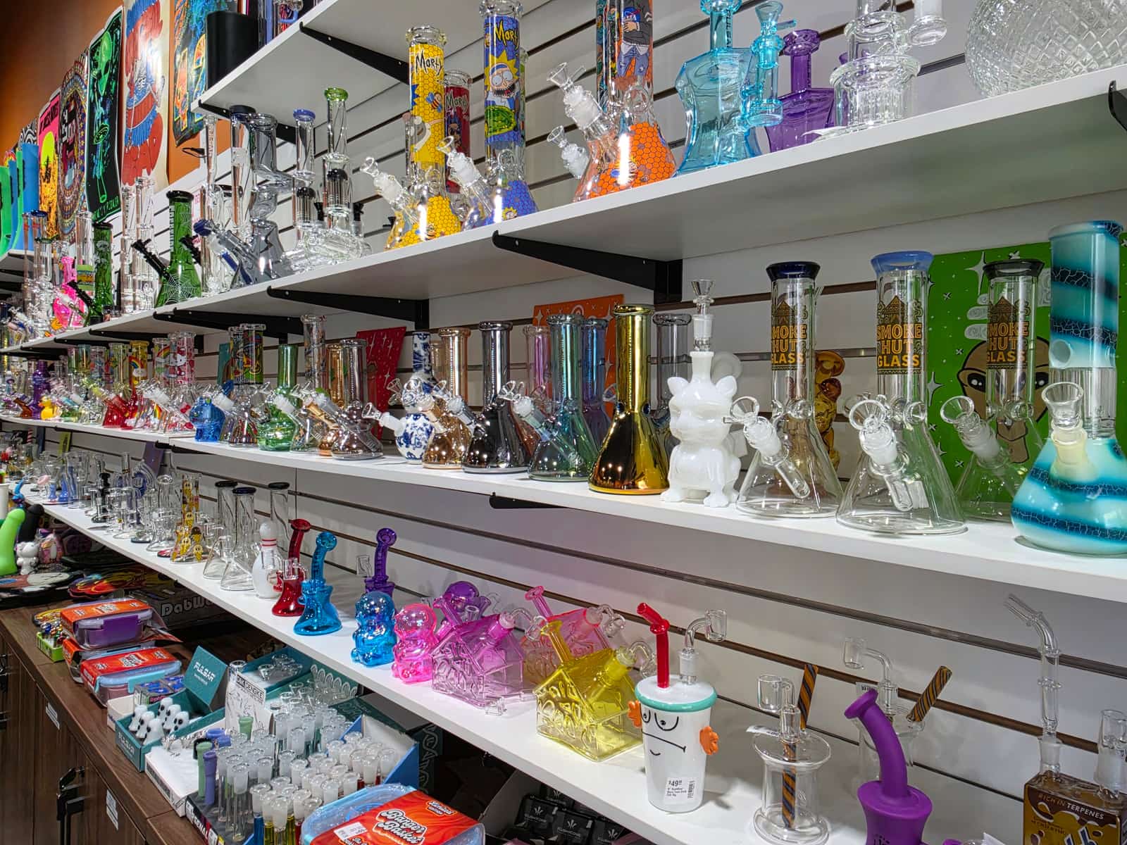 The Smoke Hut's glass wall: shelves of bongs, rigs and hand pipes.